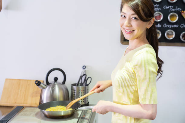 istock asian woman cooks in a kitchen,pasta, 1291514860