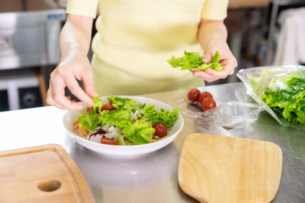 istock asian woman cooks in a kitchen,hands 1291514887