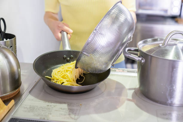 istock asian woman cooks in a kitchen,pasta,hands 1291514897