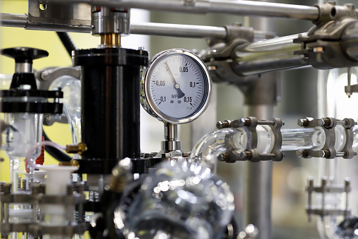 Chemical industrial equipment and pressure gauge meter. Selective focus.