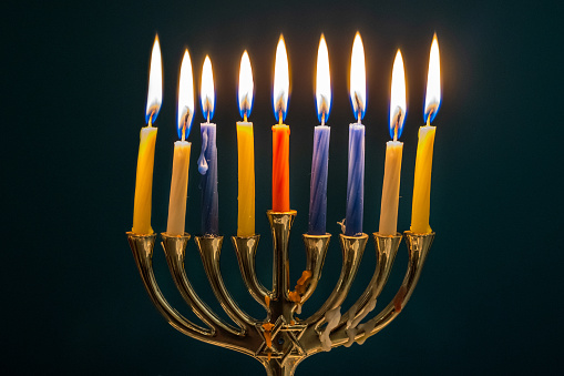 3d rendering Image of Jewish holiday Hanukkah with  gif box on a   bokeh of  gold coin, menorah or traditional Candelabra, wooden dreidels or spinning top.