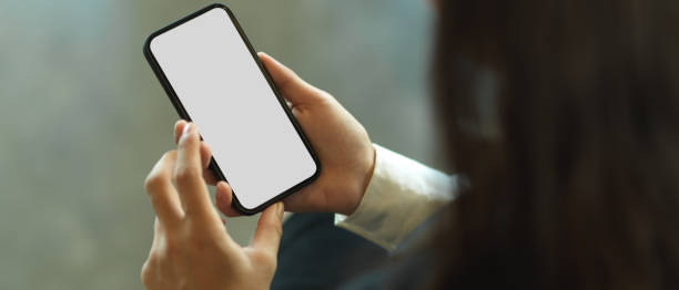 istock Top view of female hands using smartphone 1291517356
