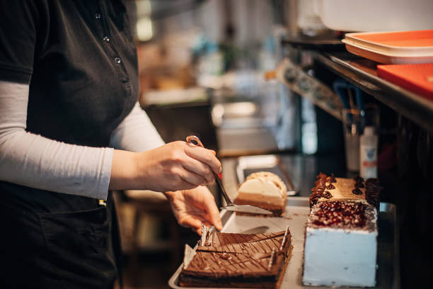 istock Female confectioner working at her cafe 1291518120