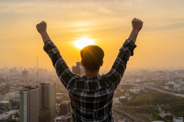 istock Asian businessman standing on a tall building. Expressing pride in experiencing success 1291520985