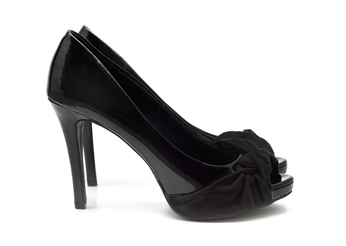 Closeup of generic black high heeled shoes on a white background.