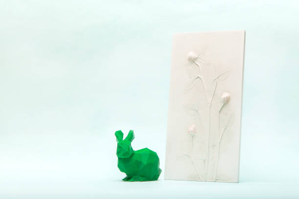 Botanical bas-relief wildflowers and poly low easter bunny for wall art. 3D Flower plaster decor. Stylish and modern interior of room. Happy Easter holiday concept in minimal style. High quality photo