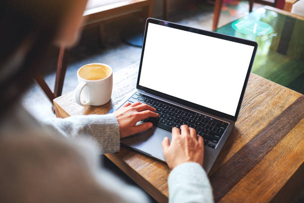 istock a woman using and typing on laptop computer keyboard with blank white desktop screen 1291527479