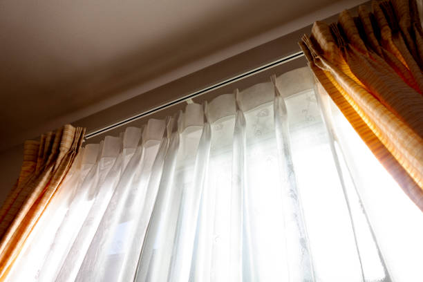 Sunlight into the room through lace fabric curtain Sunlight into the room through lace fabric curtain curtain rail stock pictures, royalty-free photos & images