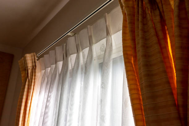 istock Sunlight into the room through lace fabric curtain 1291529320