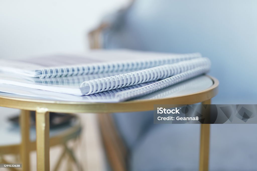 Business concept in gold and blue tones. A stack of folders is on the gold table. Space for text. Business concept in gold and blue tones. A stack of folders is on the gold table. Space for text. Copy space Guidance Stock Photo