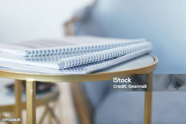 Business Concept In Gold And Blue Tones A Stack Of Folders Is On The Gold Table Space For Text Stock Photo - Download Image Now