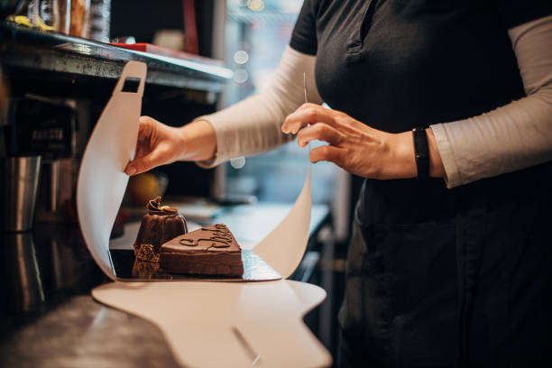 istock Female confectioner working at cafe 1291535261