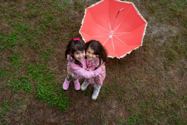 istock Kids enjoying the rain 1291537121