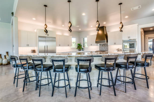 istock Eight stools around boomerang shaped kitchen island 1291541150