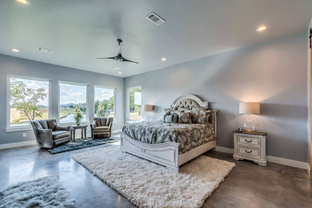 istock Spacious bedroom with white and grey colors 1291541174