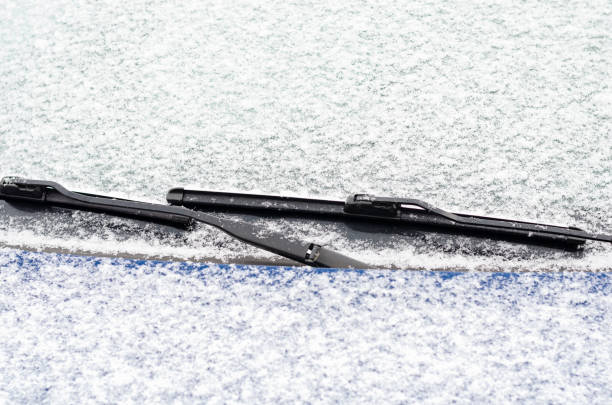 istock Car windows and wipers covered with snow in winter 1291541450