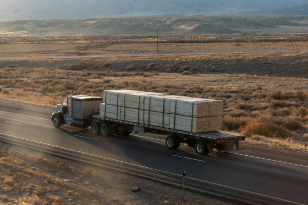 istock Long Haul Semi Trucks on A Two Way Highway 1291541630