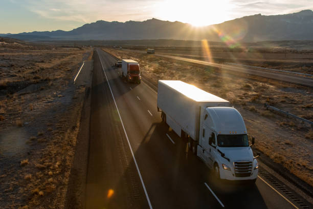 istock Long Haul Semi Trucks on A Two Way Highway 1291541631