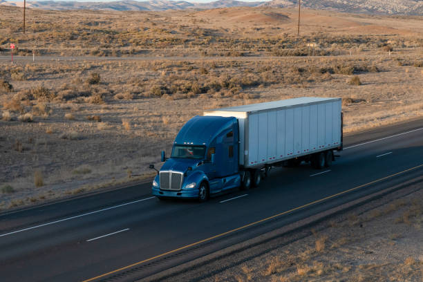 istock Long Haul Semi Trucks on A Two Way Highway 1291541637