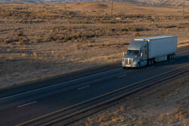 istock Long Haul Semi Trucks on A Two Way Highway 1291541640