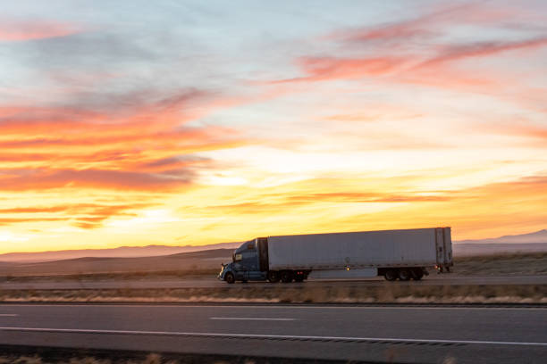 istock Long Haul Semi Trucks on A Two Way Highway 1291541644