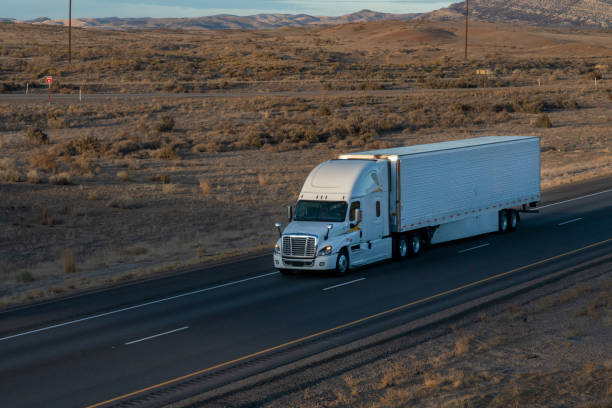 istock Long Haul Semi Trucks on A Two Way Highway 1291541684