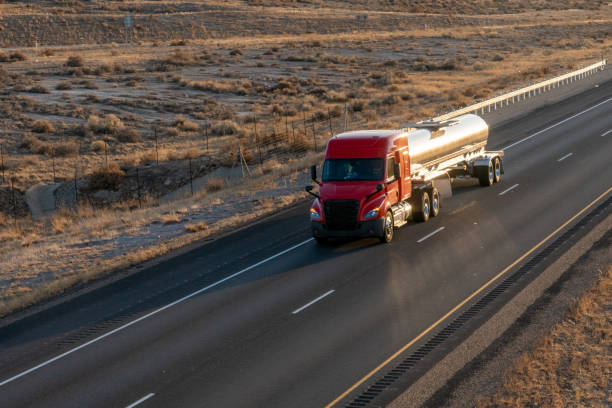 istock Long Haul Semi Trucks on A Two Way Highway 1291542195