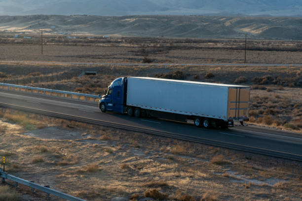 istock Long Haul Semi Trucks on A Two Way Highway 1291542215