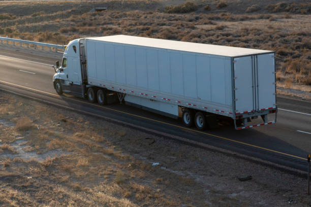 istock Long Haul Semi Trucks on A Two Way Highway 1291542216