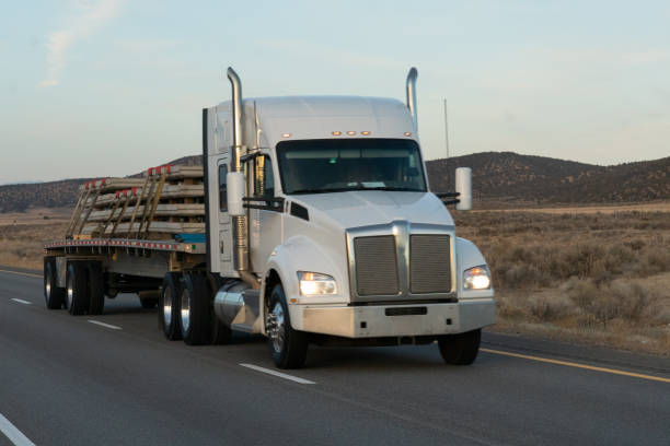 istock Long Haul Semi Trucks on A Two Way Highway 1291542232