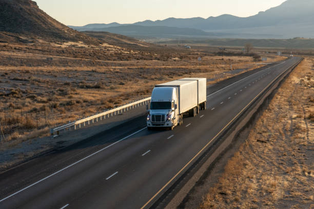 istock Long Haul Semi Trucks on A Two Way Highway 1291542245