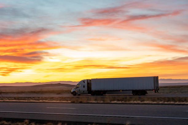 istock Long Haul Semi Trucks on A Two Way Highway 1291542255
