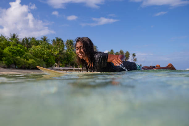 istock Paddling back to the island after a surf. 1291542341