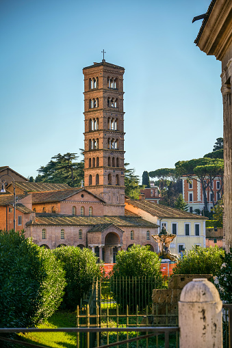 The light of sunset illuminates the Aventine Hill and the bell tower of Santa Maria in Cosmedin church, in whose entrance there is the famous Bocca della Verità (Mouth of Truth), also famous by the film Roman Holiday (1953), with Audrey Hepburn and Gregory Peck. Image in High Definition format