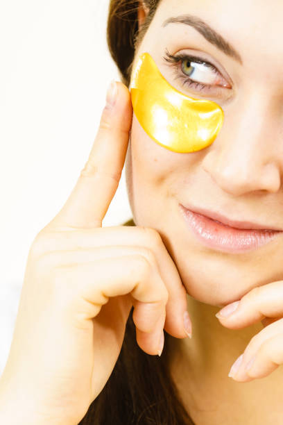 istock Woman with gold patches under eyes 1291545740