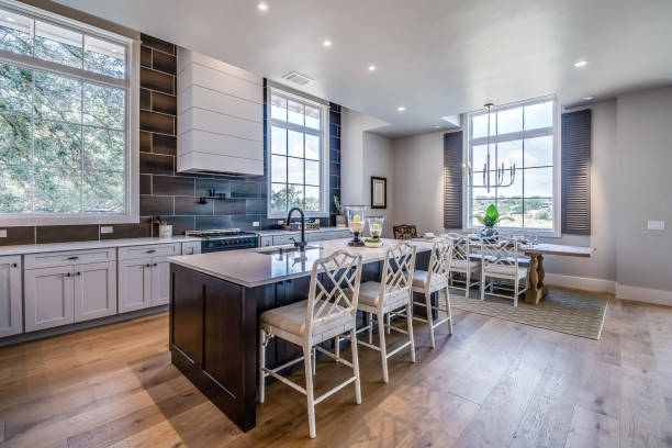 istock Contrasting lights and darks in kitchen and dining area 1291546842