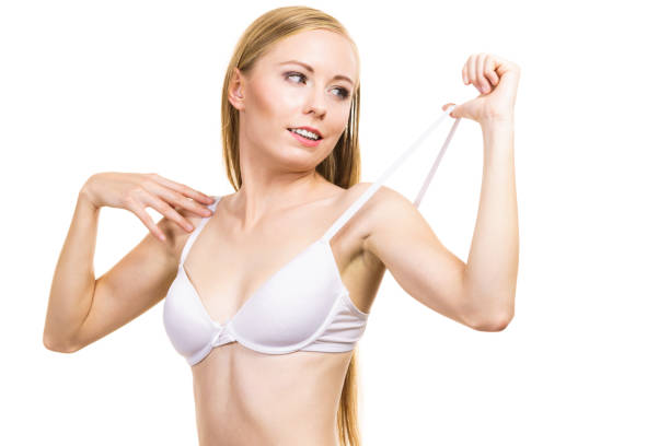 istock Young woman holding bra strap 1291547152