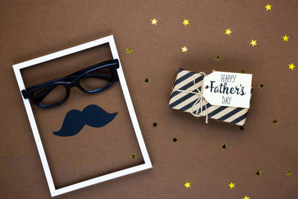istock glasses, mustache, and gift for father's day, top view 1291549371