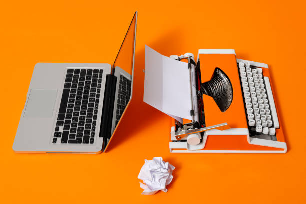 istock Digital and analog – Laptop and 70s Typewriter 1291549442