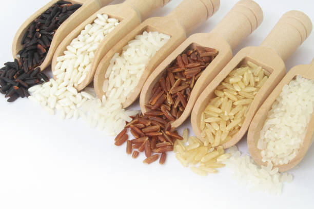 istock Different kinds of rice in wooden scoops close up, 1291551586