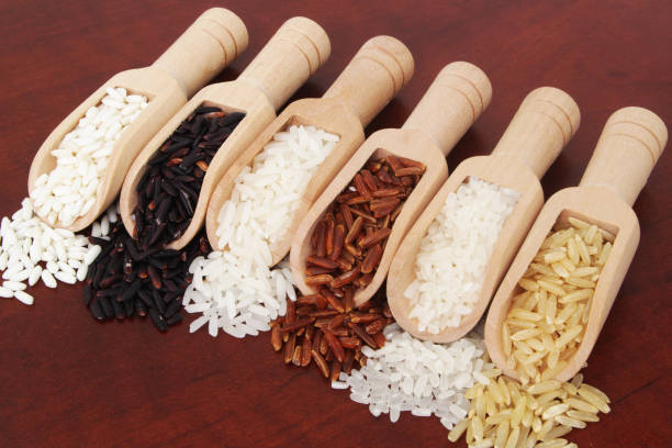 istock Different kinds of rice close up, white, brown, red and black rice. 1291551649