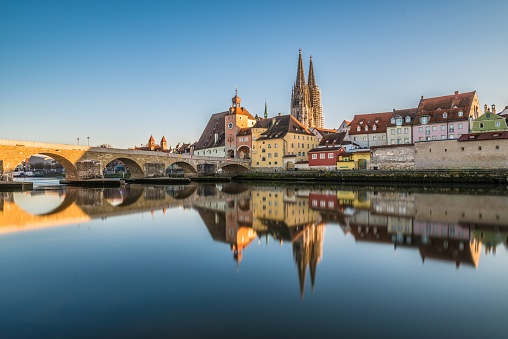 Famous city view of Regensburg and promenade with stone bridge the river Danube the historical old town and the cathedral St. Peter, Germany