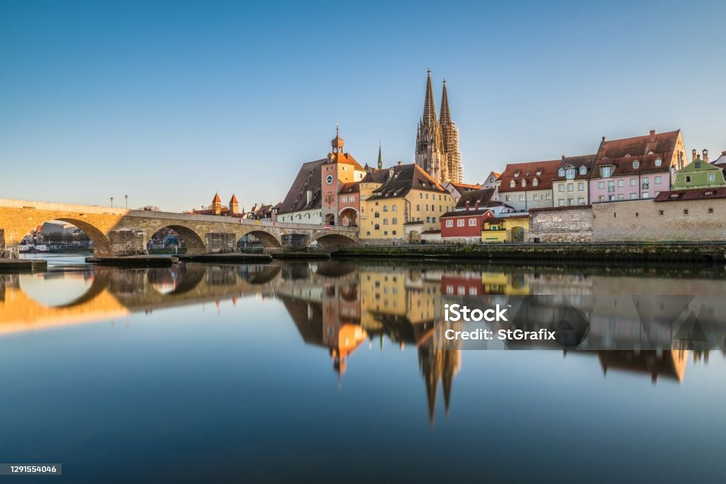 Famous city view of Regensburg and promenade with stone bridge the river Danube the historical old town and the cathedral St. Peter, Germany Regensburg Stock Photo