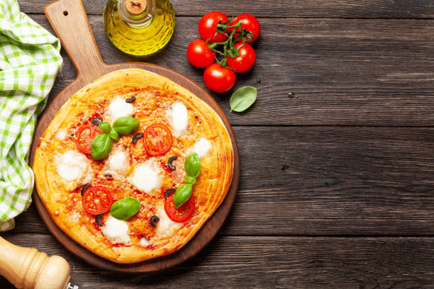istock Tasty homemade pizza with tomatoes and basil 1291554286