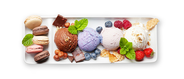 Berry, vanilla and chocolate ice cream sundae and macaroon sweets. Isolated on white background. Top view flat lay