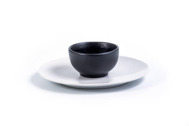 istock Black Bowl in White Plate on White 1291559779