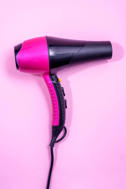 istock Hairdryer on light pink background 1291559782