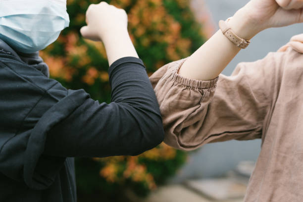 istock New greeting style in pandemic situation, elbow meet elbow 1291562131