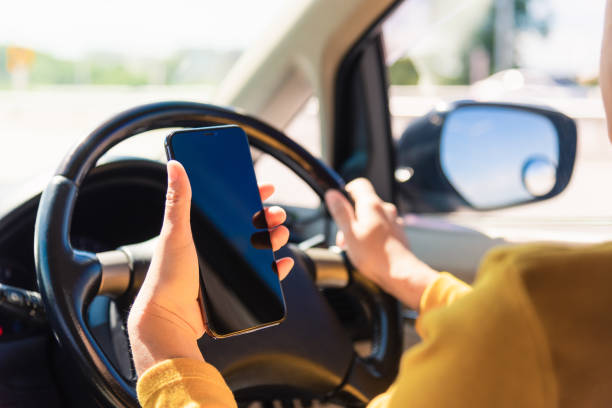 istock woman inside a car and using a hand holding mobile smartphone 1291564173
