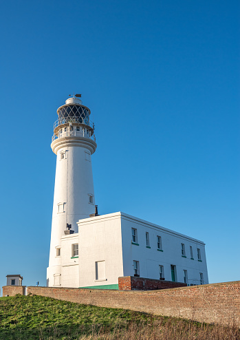 The Lighthouse at Flamborough Head a white building on a sunny day with blue sky background